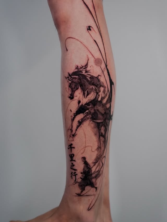 Ink-wash horse tattoo with Chinese calligraphy on lower leg