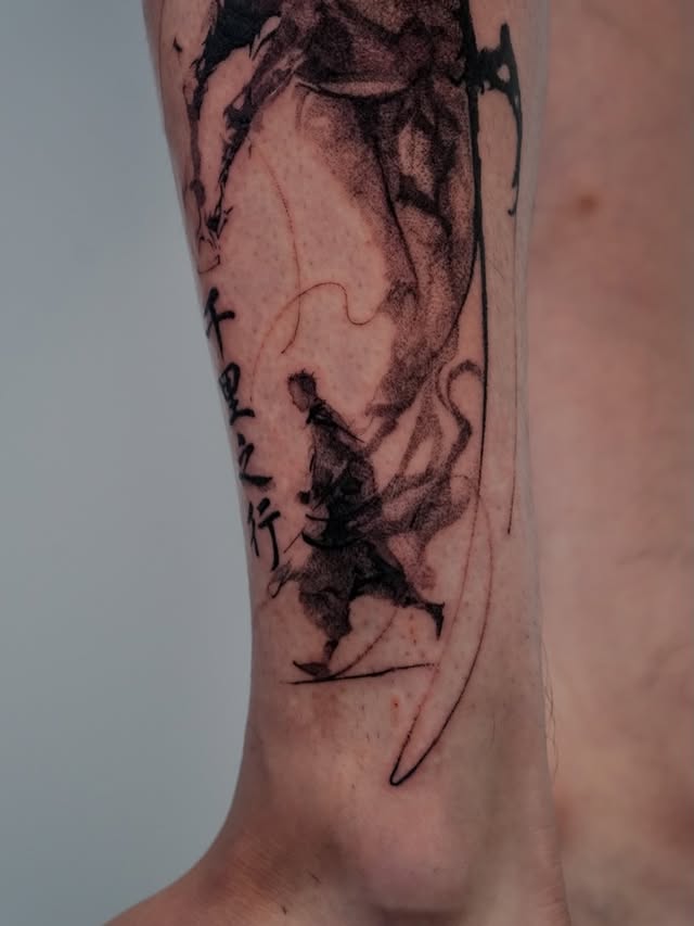 Close-up of ink-wash horse and calligraphy tattoo
